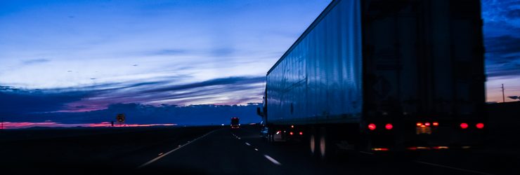 Large truck for shipping goods on a highway after sunset