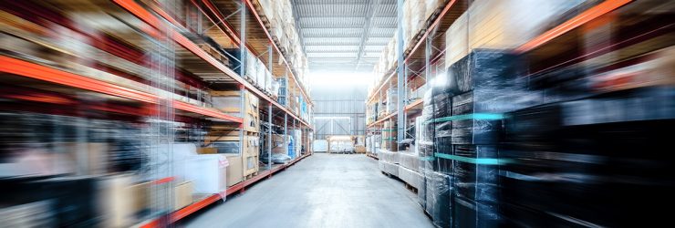 Warehouse industrial and logistics companies. Commercial warehouse. Boxes and crates stocked on the shelves of three storey. Motion blur effect.